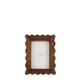Wooden photo frame with scalloped edges on a white background