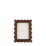 Wooden picture frame with scalloped edge on a white background