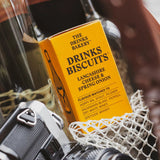 Bottle of drinks, biscuits, and a camera in a basket with a blurred background
