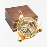 Gold sundial with wooden box on a white background