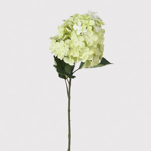 This green hydrangea spray is a really great example of a faux flower. Add as a stem to a bud vase or incorporate in to a floral display.